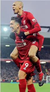  ?? AP ?? Roberto Firmino (left) of Liverpool celebrates with teammate Fabinho after scoring his side’s second goal during their English Premier League match against Crystal Palace at Anfield on Saturday. Liverpool won 4-3.