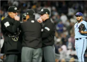  ?? FRANK FRANKLIN II - THE ASSOCIATED PRESS ?? Toronto Blue Jays relief pitcher Yimi Garcia watches as home plate umpire Lance Barrett, left, talks with other upmires after Garcia hit New York Yankees’ Josh Donaldson with a pitch during the sixth inning of a baseball game, Tuesday, May 10, 2022, in New York.