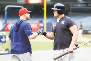  ?? Jim McIsaac / Getty Images ?? Tjhe Red Sox’s Steve Pearce, left, talks with Luke Voit of the Yankees during batting practice at Yankee Stadium on Thursday.