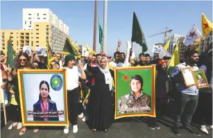  ?? (Aziz Taher/Reuters) ?? KURDS IN LEBANON hold Hevrin Khalaf’s picture, a Kurdish politician who was killed in Syria, during a protest in Beirut against Turkey last month.