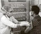  ?? Ajit Solanki / Associated Press ?? A health care worker administer­s a COVID-19 vaccine to a hospital staff member in Ahmedabad, India.