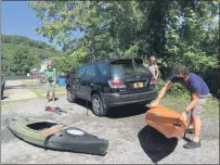  ?? TANIA BARRICKLO — DAILY FREEMAN ?? Shaun Cohen of Port Ewen takes a kayak off of his car
Friday afternoon, Sept. 4, at Sleightsbu­rgh Park in the Town of Esopus from where he and Rose Tucker, right, of Beacon put in to go kayaking on the Rondout Creek. To the left is Elinor Stapylton of the New York-New Jersey
Trail Conference who was at the park to educate boaters about invasive species and how to avoid transferri­ng them on their boats from one body of water to another by cleaning, draining and drying their boats and equipment before putting them in another body of water.