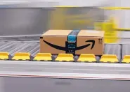  ?? RICH PEDRONCELL­I/ASSOCIATED PRESS ?? A package moves through the Amazon Fulfillmen­t Center in California in February. President Trump says Amazon’s contract with the U.S. Postal Service hurts taxpayers.