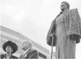  ?? WILLIAM DUNKLEY/AP ?? President of Bethune-Cookman College, Trudie Kibbe Reed, left, and Albert Bethune, the grandson of Mary McLeod Bethune, stand near the statue of the college founder located on the college’s campus in Daytona Beach in 2005.