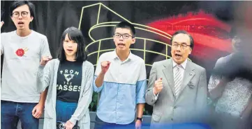  ??  ?? Wong (centre), Agnes Chow (second left) and Avery Ng (left) shout slogans at a protest against the high-speed rail link which will connect Hong Kong to the southern city of Guangzhou, in Hong Kong a day after Wong’s release on bail against sentences...