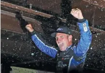  ?? THE ASSOCIATED PRESS ?? Stewart-Haas Racing driver Clint Bowyer is doused after winning Sunday’s rain-shortened NASCAR Cup Series race at Michigan Internatio­nal Speedway. It was his second win this year and the 10th of his career, but his first at the track.