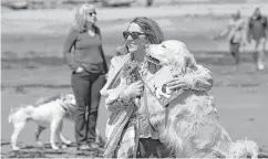  ?? Robert F. Bukaty / Associated Press ?? Dog walkers gather to remember former first lady Barbara Bush at Gooch's Beach in Kennebunk, Maine. The former first lady loved to walk her dogs and chat with the locals during summer visits.