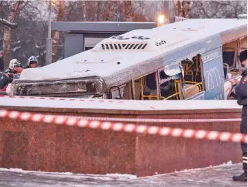  ??  ?? Rescuers pull out a city bus after it ploughed into a pedestrian underpass in western Moscow . — AFP photo