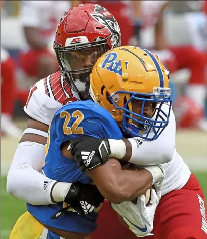  ?? Matt Freed/ Post- Gazette ?? N. C. State linebacker Vi Jones wraps up Pitt running back Vincent Davis in the Panthers’ 30- 29 loss Saturday at Heinz Field. Davis found the going tough, managing just 40 yards on 15 carries.