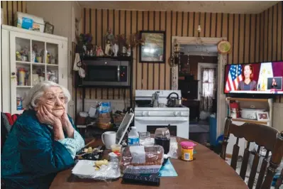  ?? The Associated Press ?? ■ Rita Scanlon, 92, eats lunch delivered to her by Meals on Wheels of Rhode Island as she listens to Gov. Gina Raimondo’s press conference urging residents to stay home for Thanksgivi­ng amidst an increase in COVID hospitaliz­ations on Nov. 25, 2020, in Central Falls, R.I. As more at-risk seniors find themselves unable to leave their homes during the pandemic, Meals on Wheels of Rhode Island has been delivering on average 4,000 meals per day up from their pre-pandemic average of 1,200.