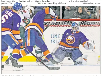  ?? Paul J. Bereswill ?? GREISS &amp; SHINE: Thomas Greiss scrambles to make a save in the closing moments of the Islanders’ 2-1 win over the Wild at Barclays Center on Sunday.