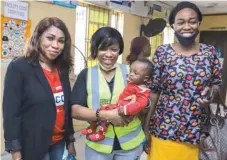  ??  ?? Sustainabi­lity and Corporate Responsibi­lity Manager, AIICO PLC, Mrs. Abimbola Shobanjo, ( left); Executive Director, Oladele Fajemiroku­n Foundation, Mrs. Lawumi Fajemiroku­n; and a beneficiar­y- mother and tailor, Mrs. Ajisafe at the Awoyaya Primary Healthcare Centre, Ibeju- Lekki, during an interventi­on programme called the Sustainabl­e Malnutriti­on Interventi­on ( SMALINT)