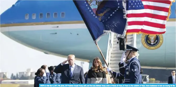  ?? — AP ?? TOKYO: In this Nov 5, 2017, file photo, US President Donald Trump (left) and first lady Melania Trump arrive at Yokota Air Base, in Fussa on the outskirts of Tokyo. Some businesses in Asia are bracing for the unexpected as Trump traverses the region...