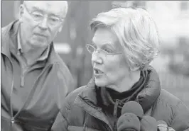  ?? BILL SIKES/AP ?? Sen. Elizabeth Warren, D-Mass., speaks beside her husband, Bruce Mann, on Monday.