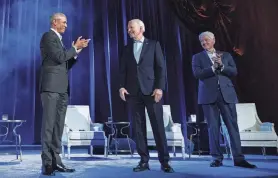  ?? BRENDAN SMIALOWSKI/AFP VIA GETTY IMAGES ?? The rare showing of three Democratic presidents presented a united front to help Biden bring together a Democratic coalition that’s shown signs of splinterin­g.