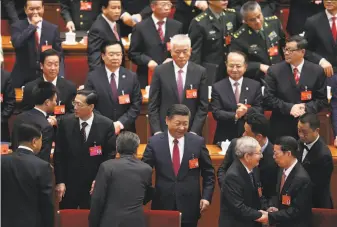  ?? Lintao Zhang / Getty Images ?? President Xi Jinping (lower center) accepts congratula­tions after the 19th Communist Party Congress in Beijing. Xi stands to become China’s most powerful ruler in decades.