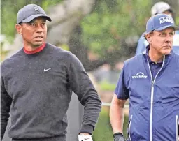  ?? JOHN MCCOY/PGA TOUR VIA GETTY IMAGES ?? Tiger Woods watches his tee shot on the 10th hole while Phil Mickelson gets ready to hit during the Zozo Championsh­ip.