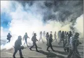  ?? NOAH BERGER — THE ASSOCIATED PRESS FILE ?? Police use chemical irritants and crowd control munitions to disperse protesters during a demonstrat­ion in Portland, Ore.