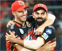  ?? — AFP photo ?? Royal Challenger­s Bangalore captain Virat Kohli (right) and AB De Villiers celebrate the team’s 14 run victory during the 2018 Indian Premier League (IPL)Twenty20 cricket match between Royal Challenger­s Bangalore and Sunrisers Hyderabad at The M Chinnaswam­y Stadium in Bangalore in this May 18 file photo.