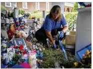  ?? KRISTEN ZEIS / THE VIRGINIAN-PILOT ?? Anne Miller, Virginia Beach History Museums coordinato­r, works on taking down the memorial in honor of the 12 victims who lost their lives in the May 31 mass shooting.