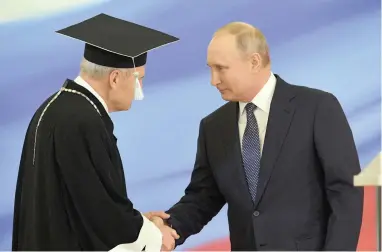  ?? PICTURE: AP ?? OMNIPRESEN­T: Vladimir Putin shakes hands with Constituti­onal Court chairperso­n Valery Zorkin during his inaugurati­on ceremony for his fourth term as Russia’s president in the Grand Kremlin Palace, Moscow, yesterday.