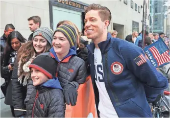  ?? MIKE STOBE, GETTY IMAGES FOR THE USOC ?? Shaun White, right, posing with fans in New York on Wednesday, says of his fourth-place finish at the 2014 Sochi Games, “I was getting a little burnt on snowboardi­ng. It was just tough.”