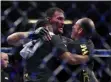  ?? HANS GUTKNECHT — SOUTHERN CALIFORINA
NEWS GROUP ?? Stipe Miocic is congratula­ted by his coaches Marcus Marinelli, right, and Pablo Castro after winning the UFC heavyweigh­t title on Aug. 17 in Anaheim, Calif.