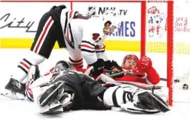  ?? PAUL SANCYA/AP ?? Red Wings forward Matthew Ford scores a goal on Blackhawks goalie Robin Lehner with Joni Tuulola defending in the second period Tuesday.