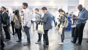  ?? PATRICK T. FALLON/BLOOMBERG NEWS ?? Attendees of a tech job fair in Los Angeles. China is trying to attract top-calibre engineers, scientists and other skilled technical workers, particular­ly U.S.-based Chinese profession­als.