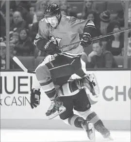  ?? Jae C. Hong Associated Press ?? CAM FOWLER of the Ducks jumps to avoid a collision with the Avalanche’s Gabriel Landeskog during the first period of Thursday’s game in Anaheim.