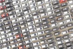  ??  ?? Electric cars are seen at a parking lot of an automobile factory in Xingtai, Hebei province, China. — Reuters photo