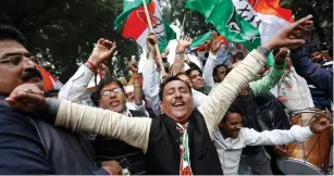  ?? (Adnan Abidi/Reuters) ?? WORKERS FROM India’s main opposition Congress Party celebrate in Delhi yesterday after the party announced Rahul Gandhi as its president.