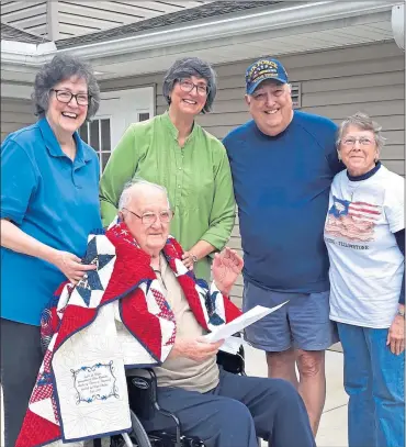  ?? SUBMITTED PHOTO ?? Sgt. John Homcha of Exeter Township received a Quilt of Valor during a ceremony held at his residence on Oct. 11. With him are, from left, daughters Michele Green and Marie Kaminskas, son Michael Homcha and quilt maker Patricia Buzzard.