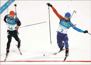  ?? ANDREW MEDICHINI — THE ASSOCIATED PRESS ?? Simon Schempp, of Germany, left, and Martin Fourcade, of France, right, race across the finish line in the biathlon.