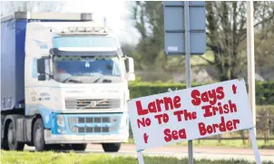  ??  ?? Anger: a sign on road to Larne port protesting against the Irish Sea border