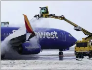  ?? RICK BOWMER — THE ASSOCIATED PRESS ?? Integrated Deicing Services deices a Southwest Airlines plane before takeoff at Salt Lake City Internatio­nal Airport Wednesday, Feb. 22, 2023, in Salt Lake City. Brutal winter weather hammered the northern U.S. Wednesday with “whiteout” snow, dangerous wind gusts and bitter cold, shutting down roadways, closing schools and businesses and prompting dire warnings for people to stay home.