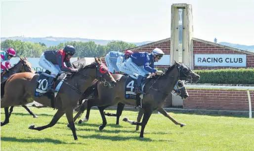  ?? PHOTO: GREGOR RICHARDSON ?? He’s done it . . . Showemhowi­tsdone, in the hands of Terry Moseley, wins the Dunedin Guineas at Wingatui on Saturday, ahead of The Gift, ridden by Kozzi Asano (inside). Gone With The Wind, ridden by Chris Johnson, finished third.