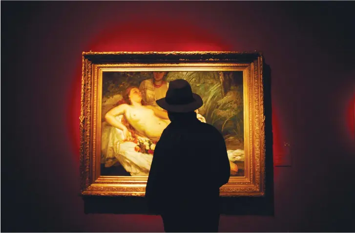  ?? (Reuters) ?? A MAN looks at a painting titled ‘The Bathers’ during a 2008 exhibition devoted to finding owners of paintings looted by the Nazis.