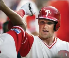  ?? LAURENCE KESTERSON — THE ASSOCIATED PRESS ?? The Phillies’ Rhys Hoskins is cheered in the dugout after hitting a two-run home run during the first inning Friday.