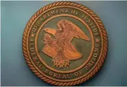  ?? AP PHOTO/CAROLYN KASTER ?? The seal for the Federal Bureau of Prisons is seen in 2022 at Federal Bureau of Prisons headquarte­rs in Washington.