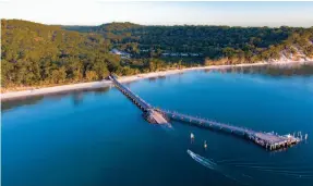  ?? Photograph­y by Danielle Lancaster, Anders Bergersen & Kingfisher Bay Resort. ?? From top: The highway that is 75 Mile Beach; The pool at Kingfisher Bay Resort; Kingfisher Bay Resort tucks into the landscape and is easily accessed by boat thanks to its large jetty.
