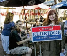  ?? RALPH BARRERA / AMERICAN-STATESMAN 2015 ?? Defense attorney Chantal Eldridge poses with her campaign sign during her 2015 run for the 450th District judgeship. She won the Democratic primary for the 331th District judgeship this year, and will run unopposed.