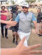  ?? RAMIREZ / USA TODAY SPORTS ORLANDO ?? Andrew Landry accepts fans' congratula­tions near the 18th tee on his way to victory in The American Express tournament Sunday.