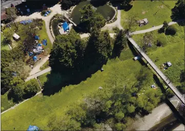  ?? PHOTOS BY SHMUEL THALER — SANTA CRUZ SENTINEL FILE ?? A federal judge ruled Tuesday that the homeless encampment at San Lorenzo Park, at top left, may be moved down into the Benchlands, at bottom.