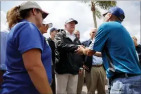  ?? THE ASSOCIATED PRESS ?? President Donald Trump meets with people impacted by Hurricane Irma during a tour at Naples Estates, Thursday, Sept. 14, 2017, in Naples, Fla.