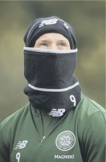  ??  ?? 0 Celtic striker Leigh Griffiths wraps up against Storm Ali for a training session at Lennoxtown.