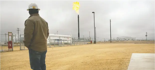  ?? SPENCER PLATT / GETTY IMAGES FILES ?? Flared natural gas is burned off at Apache Corp.’s Deadwood natural gas plant in the Permian Basin in Texas. Across the entire basin, the world’s hottest oil play, drilling budgets are being slashed and firms are laying off workers as the coronaviru­s pandemic hammers both demand and prices.