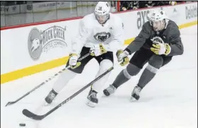  ?? Richard Brian Las Vegas Review-Journal @vegasphoto­graph ?? Golden Knights second-round draft pick Nicolas Hague, right, vies for the puck with Chris Casto during Golden Knights practice at City National Arena on Sept. 15.