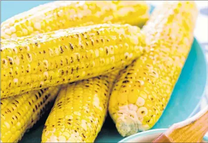 ?? JOE KELLER/AMERICA’S TEST KITCHEN VIA AP ?? Grilled corn on the cob from a recipe in “The Complete Cook’s Country TV Cookbook, 2017.”