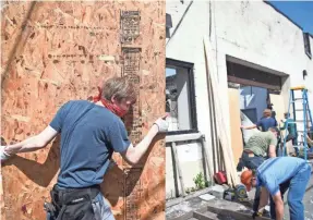  ?? JACK GRUBER/USA TODAY ?? Community members help secure buildings and clean up debris in the destroyed sections of Lake Street in Minneapoli­s on May 31.